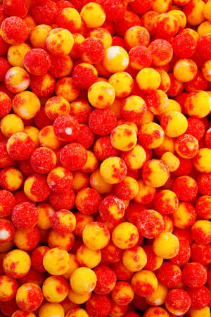Colorful red, yellow and orange candy balls in candy shopの写真素材