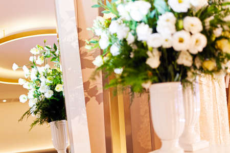 Beautiful bouquet of white flowers in wedding dress boutique, infront mirrorの写真素材