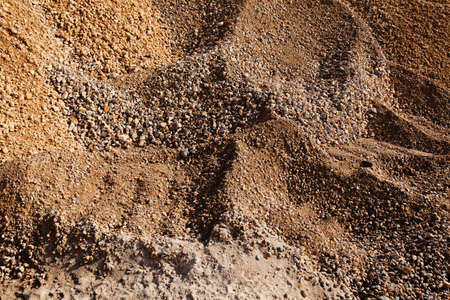 sand and gravel piles in constructionの写真素材