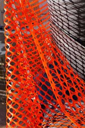 red plastic safety net for construction site, note shallow depth of fieldの写真素材