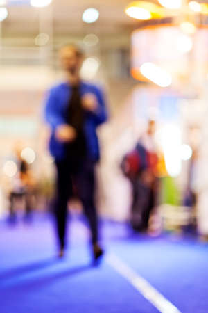 Blurred of man walking on job fair; note shallow depth of fieldの写真素材