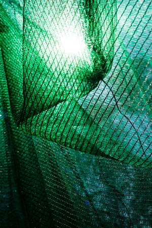 thick green plastic safety net for construction site, note shallow depth of fieldの写真素材