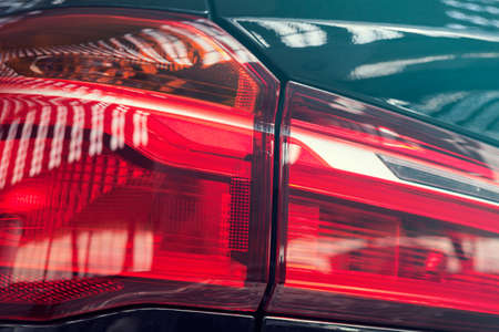reflections of light on the car headlights, note shallow depth of field