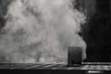 smoke coming from the chimney of the house in the winter, note shallow depth of field