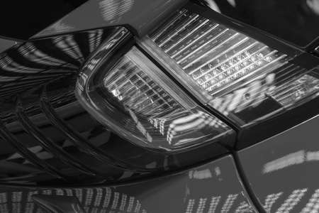 type headlights of the red vehicle, note shallow depth of fieldの写真素材