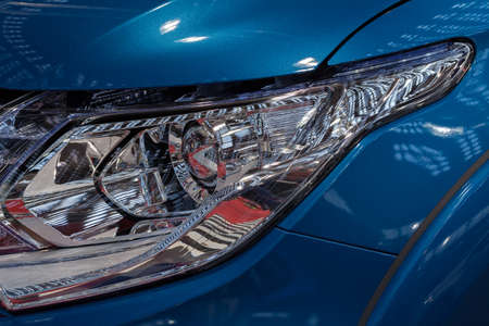 type headlights of the blue vehicle, note shallow depth of fieldの写真素材