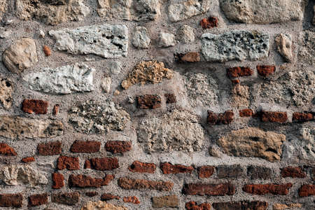 part of the old brick wall with stones