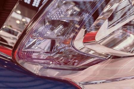 type headlights of the blue vehicle, note shallow depth of field