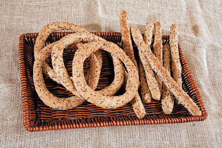 Bagels and sticks with seeds in wicker baskets