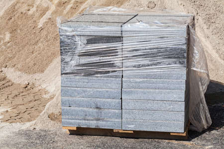 complex granite slabs packed in foil on a wooden pallet, note shallow depth of fieldの写真素材