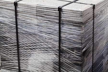 complex granite slabs packed in foil on a wooden pallet, note shallow depth of fieldの写真素材
