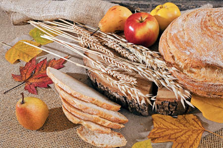 Decoration with bread, cereal and fruit on a linen backgroundの写真素材