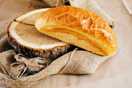 fresh loaf of bread on a wooden stumpの写真素材