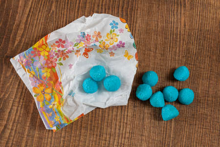 blue  sweets from paper bags, note shallow depth of fieldの写真素材