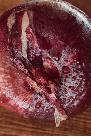 red onions on a wooden board, note shallow depth of fieldの写真素材