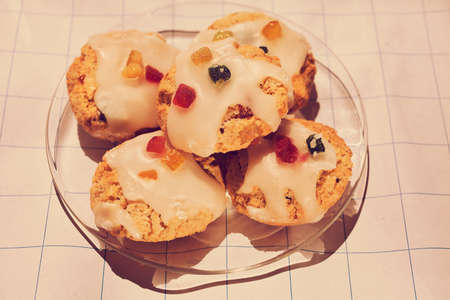biscuit with dried fruit  and a white sauce with jelly candies as decorationsの写真素材