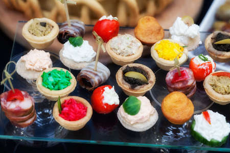 types of canapes for cocktails on a glass plate, note shallow depth of fieldの写真素材