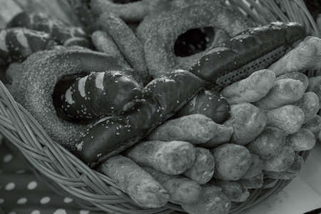 Various bakery products in a wicker basket, note shallow depth of fieldの写真素材