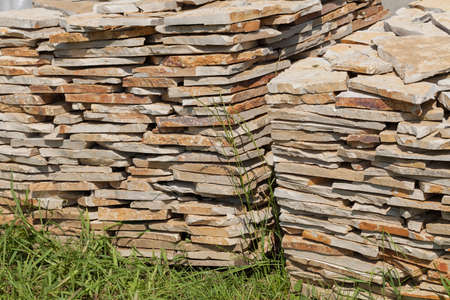 pile of stone blocks on the grass, note shallow depth of fieldの写真素材