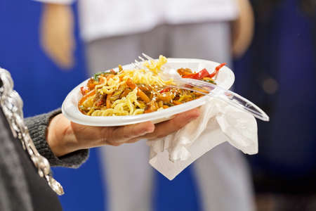 grilled vegetables with pasta on the plate in his hands, note shallow depth of fieldの写真素材