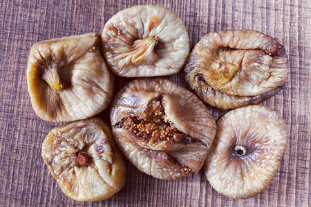 dried figs on a wooden table, note shallow depth of fieldの写真素材