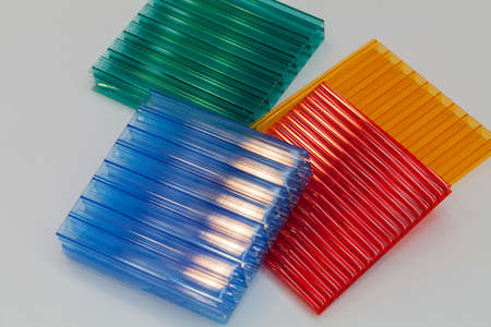 lexan samples in different colors on a white background, note shallow depth of fieldの写真素材