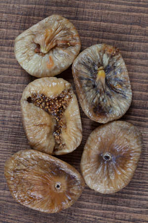 Dried figs on a wooden table, note shallow depth of fieldの写真素材