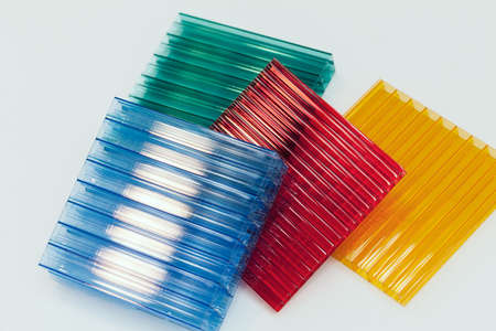 lexan samples in different colors on a white background, note shallow depth of fieldの写真素材