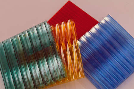 lexan samples in different colors on a white background, note shallow depth of fieldの写真素材