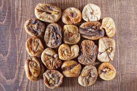 Dried figs on a wooden table, note shallow depth of fieldの写真素材