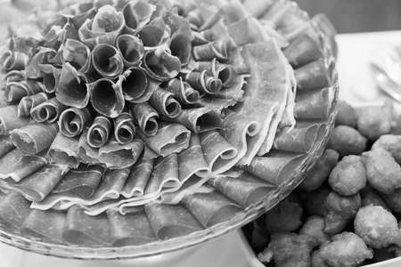 prosciutto as an appetizer served on a round plateの写真素材