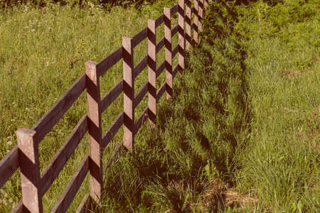 wooden fence around the farm in the forest, note shallow depth of fieldの写真素材