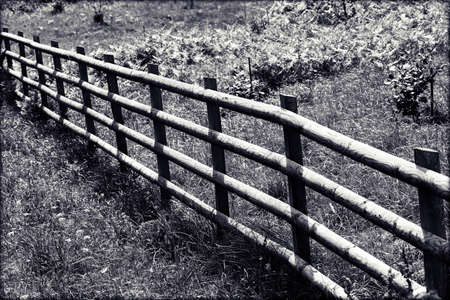 wooden fence around the farm in the forest, note shallow depth of fieldの写真素材