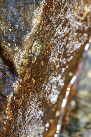 stone under the mountain water, note shallow depth of field