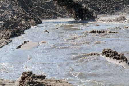 sand and mud in industrial water, note shallow depth of field