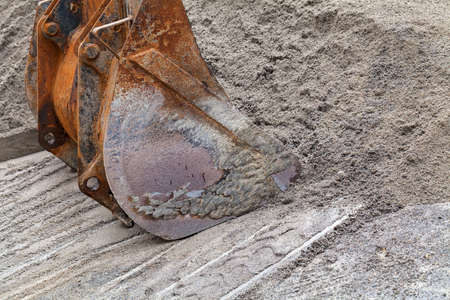 loading sand with bucket on the excavator, note shallow depth of fieldの写真素材