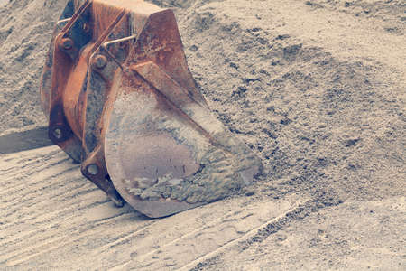 loading sand with bucket on the excavator, note shallow depth of fieldの写真素材