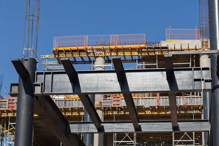 building under construction with scaffolding and crane