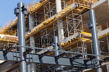building under construction with scaffolding and crane