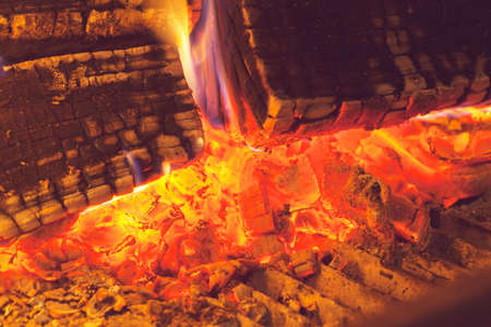 burning wooden logs in the fireplace, note shallow depth of field