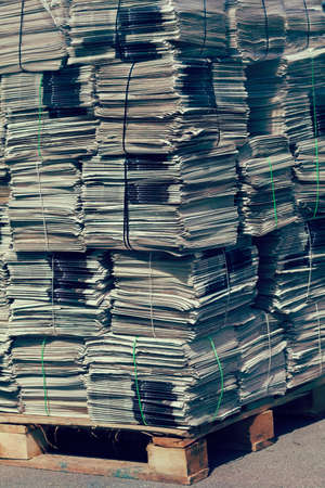 pile of newspapers for recycling in packages , note shallow depth of field