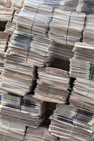 pile of newspapers for recycling in packages , note shallow depth of field