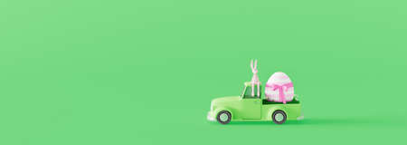 Cute Easter bunny sitting on green car and carrying colorful Easter egg. Easter holiday concept on...