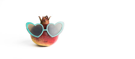 Funny pomegranate with sunglasses isolated on white backgroundの写真素材