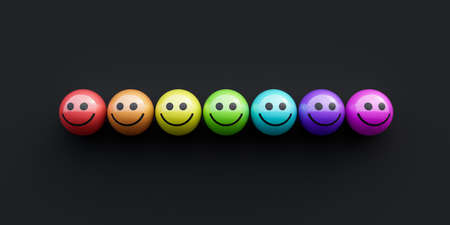 Rainbow colored balls with smiling faces lined up in row. Creative diversity concept on black background. 3d render 3d illustrationの写真素材
