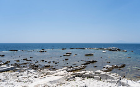 Beautiful summer Mediterranean coast with large sea stones in waterの写真素材