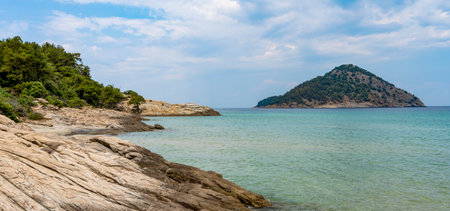 A beautiful summer coast of the Aegean Sea with a beautiful view of a deserted islandの写真素材