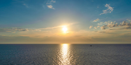Beautiful landscape with cloudy sky and sunset on the calm sea