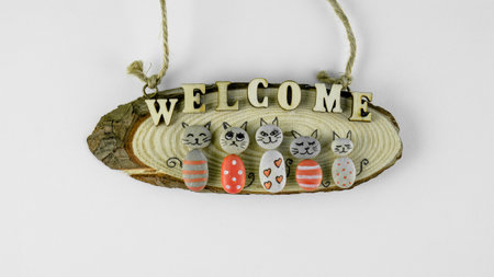 Handmade Creative concept with cats made of stone on piece of wood with welcome signの写真素材