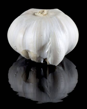 Garlic on reflective black backgroundの写真素材